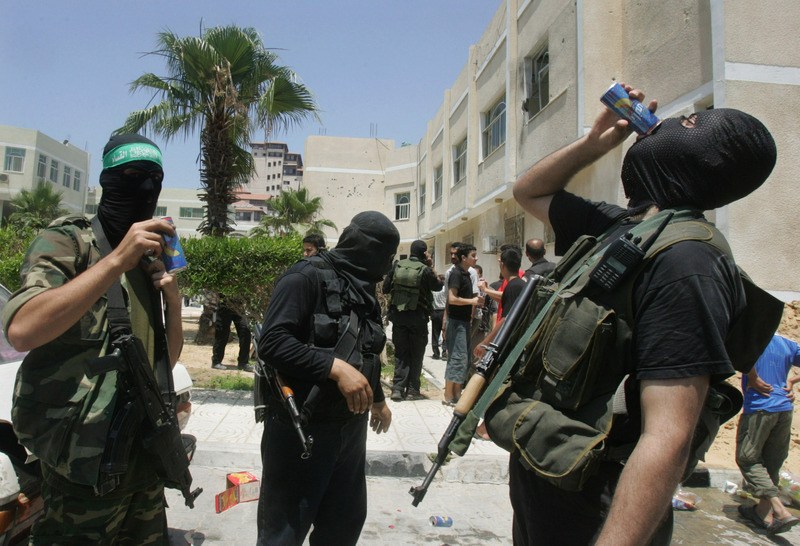 Palestinian militants from Hamas drink energy drinks as they celebrate their capture of the Preventive Security headquarters during fighting with Fatah loyalist security forces in Gaza City, Thursday, June 14, 2007. Hamas fighters overran one of the rival Fatah movement's most important security installations in the Gaza Strip on Thursday, and witnesses said the victors dragged vanquished gunmen from the building and executed them in the street. The capture of the Preventive Security headquarters was a major step forward in Hamas' attempts to complete its takeover of all of Gaza.(AP Photo/Khalil Hamra)